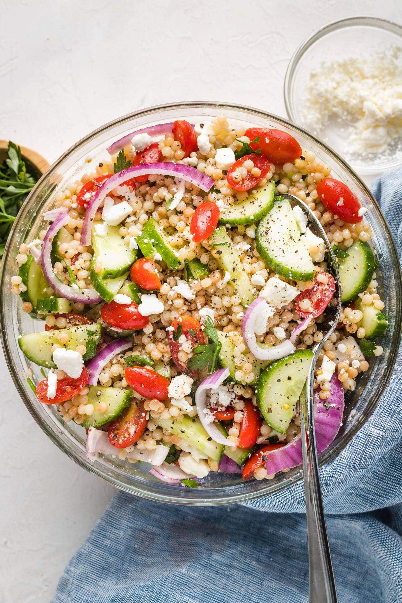 Pearl couscous salad with cucumbers, tomatoes, and feta.