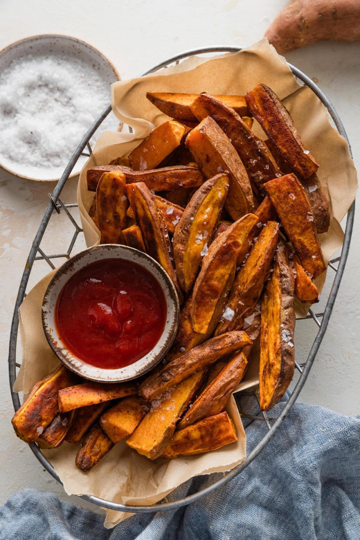 Basket full of homemade sweet potato wedges.