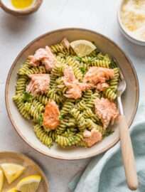 This Salmon Pesto Pasta recipe comes together in 25 minutes for a comforting yet healthy one-bowl meal. Roasting the salmon is hands-off yet delivers light flavor and texture, and using either homemade or jarred pesto to keep it flexible and weeknight-friendly.