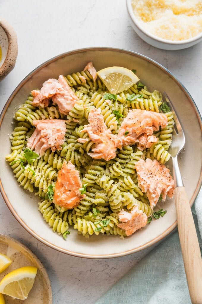 Close up of salmon pesto pasta in a bowl.