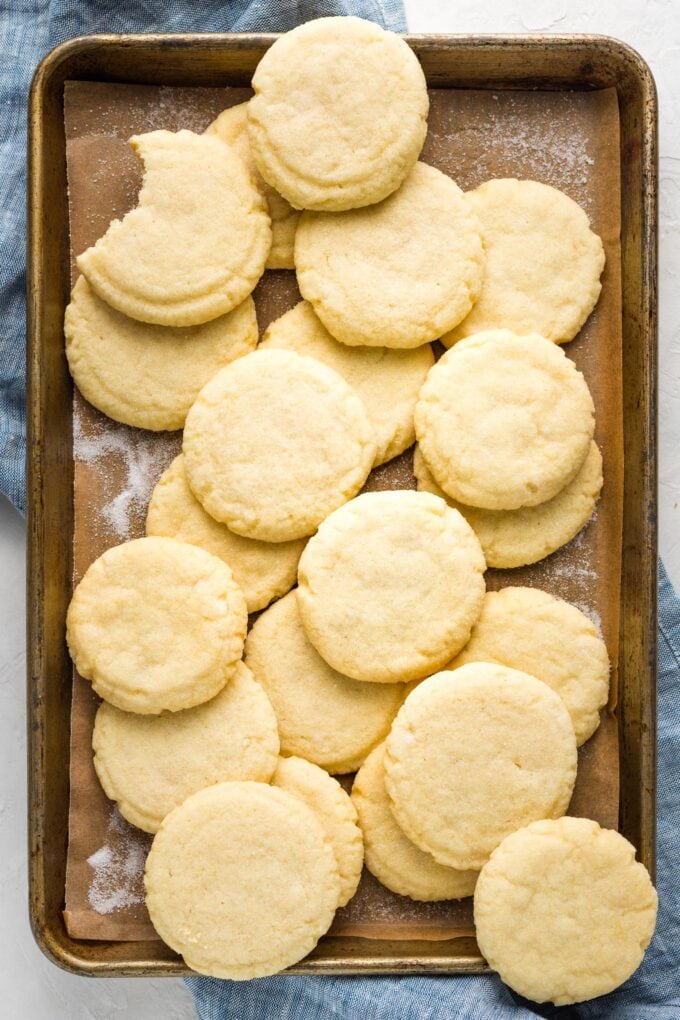 Weathered baking sheet with a batch of cookies arranged on top.