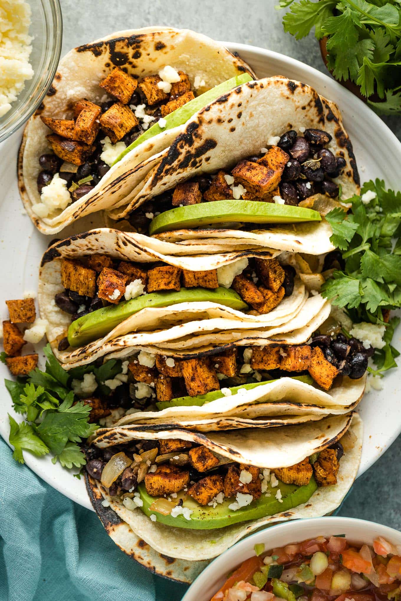 Close up of tacos on a white plate.