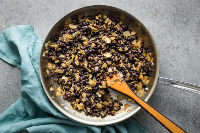 Cooked black beans in a skillet.