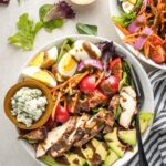 Overhead image of balsamic grilled chicken Cobb salad, served in a bowl for a large individual salad.