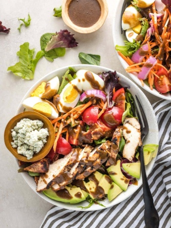 Overhead image of balsamic grilled chicken Cobb salad, served in a bowl for a large individual salad.