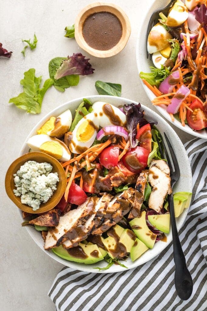 Overhead image of balsamic grilled chicken Cobb salad, served in a bowl for a large individual salad.