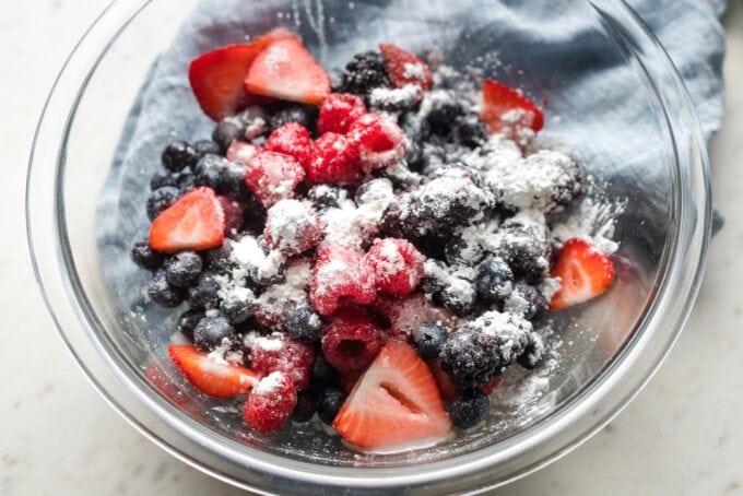 Berries coated with cornstarch in a prep bowl.