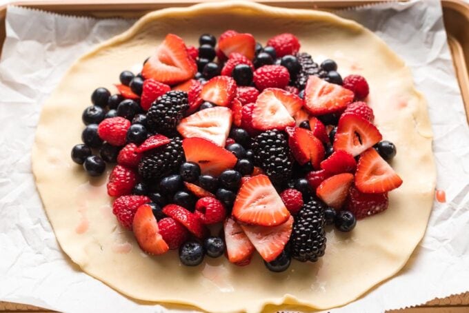 Berries mounded in the middle of an unrolled pie crust.