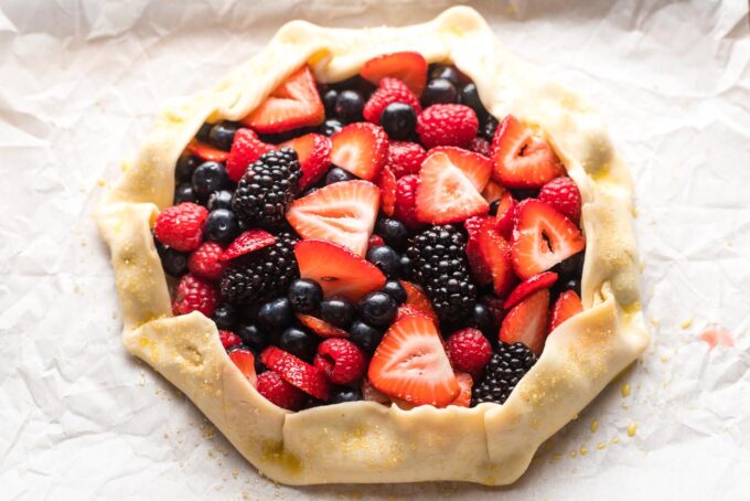 Pie crust folded up into a rim around the berries.