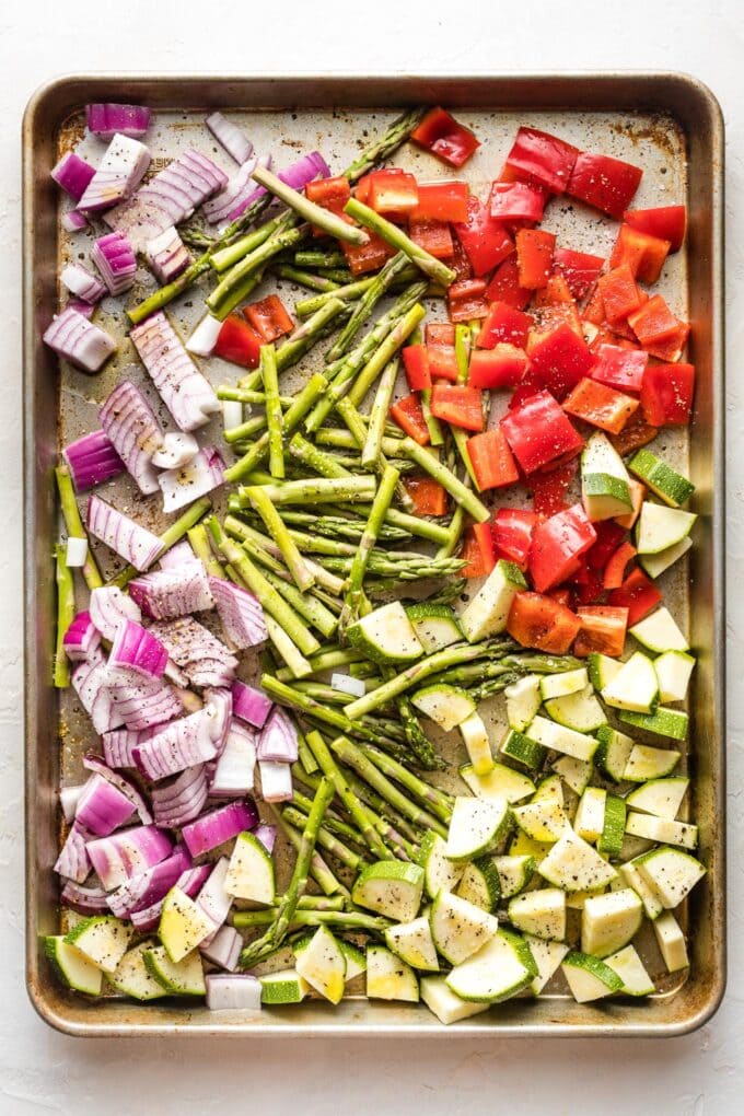 Sheet pan with cut veggies ready to roast.