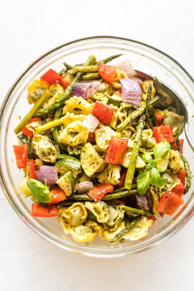 Bowl full of cheese tortellini and roasted vegetables.