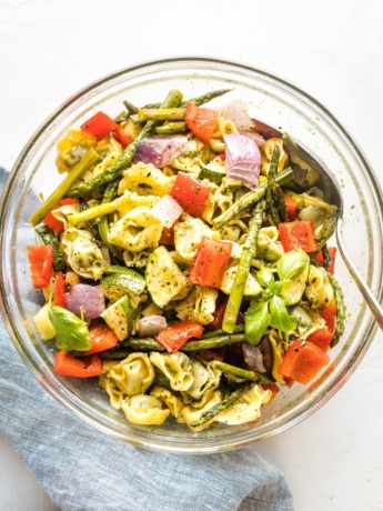 Bowl full of cheese tortellini and roasted vegetables.