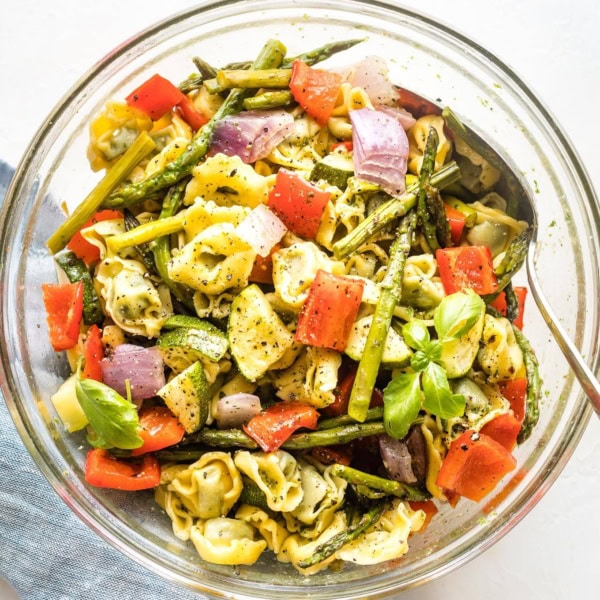 Bowl full of cheese tortellini and roasted vegetables.