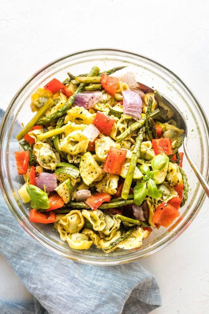 Bowl full of cheese tortellini and roasted vegetables.