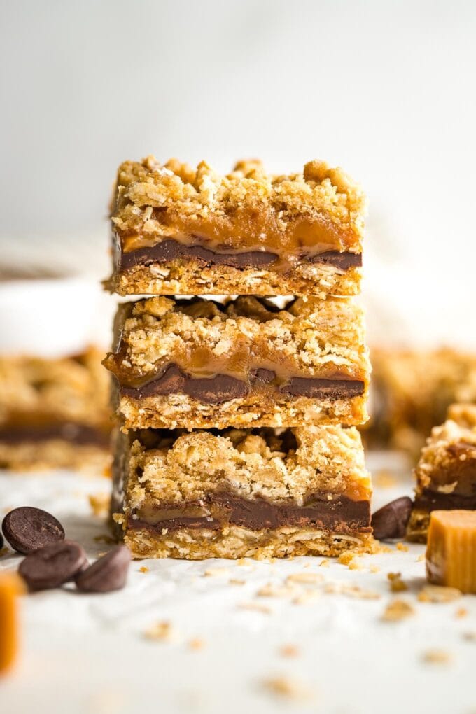 Three oat caramel bars stacked on top of each other.