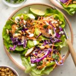 Small plate filled with three Jamaican jerk chicken lettuce wraps.