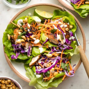 Small plate filled with three Jamaican jerk chicken lettuce wraps.