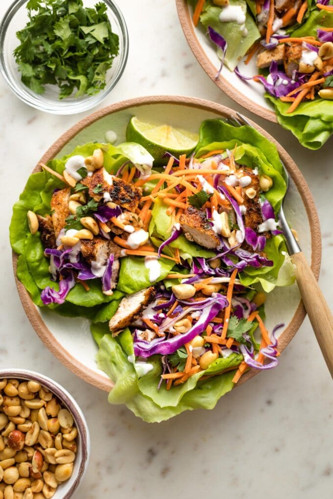 Small plate filled with three Jamaican jerk chicken lettuce wraps.