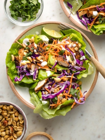 Small plate filled with three Jamaican jerk chicken lettuce wraps.