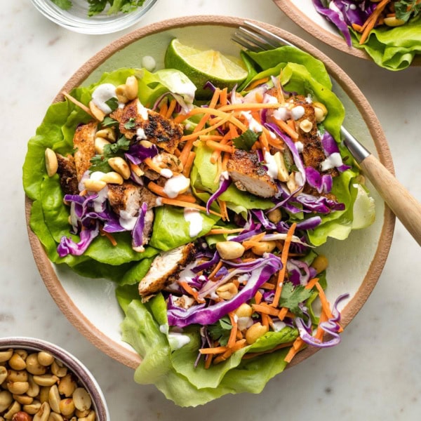 Small plate filled with three Jamaican jerk chicken lettuce wraps.