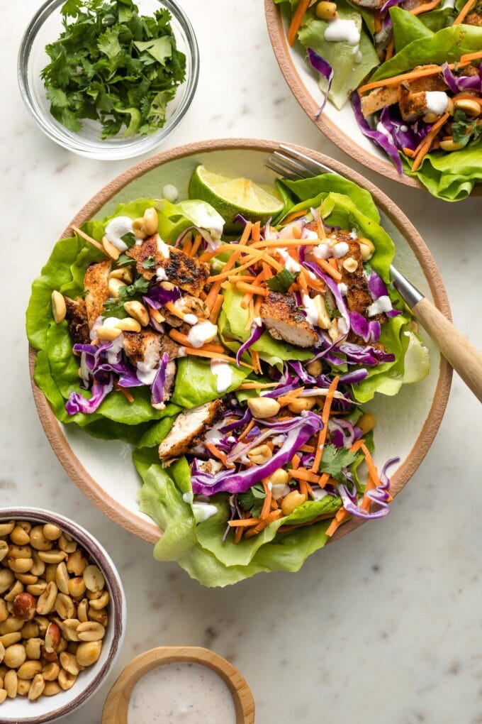 Small plate filled with three Jamaican jerk chicken lettuce wraps.