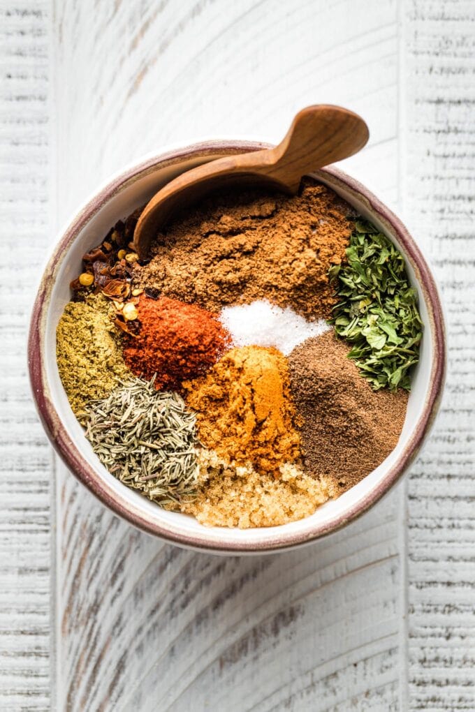 Small white bowl holding spices for Jamaican jerk seasoning.