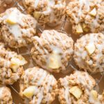 Close up of apple cinnamon oatmeal cookies drizzled with maple glaze.