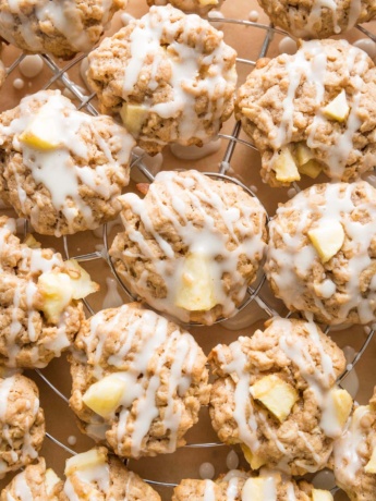 Close up of apple cinnamon oatmeal cookies drizzled with maple glaze.