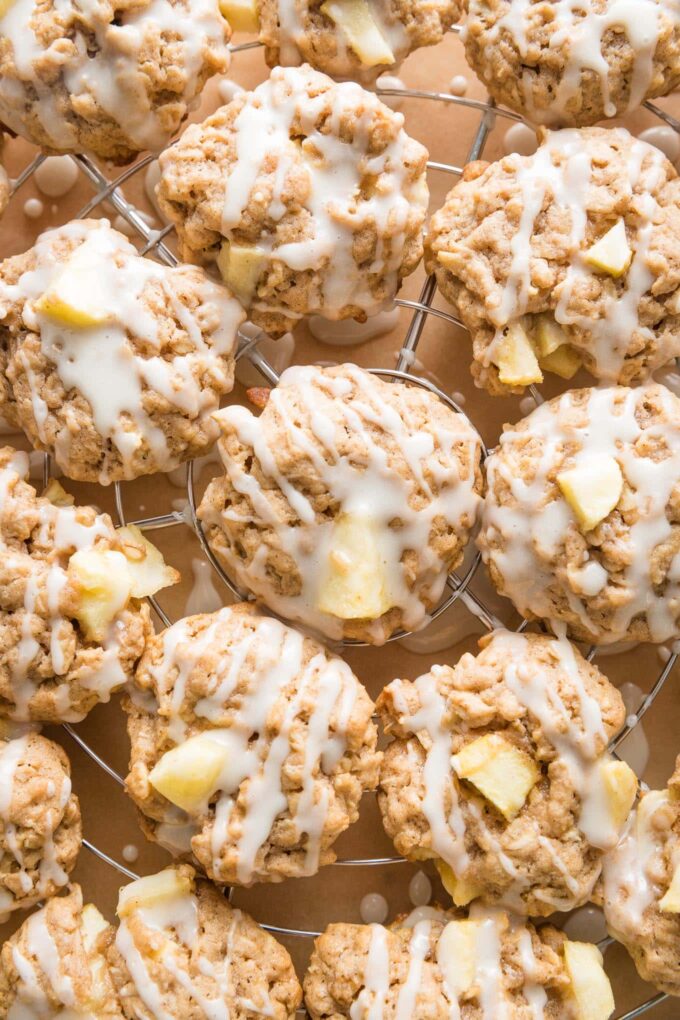 Close up of apple cinnamon oatmeal cookies drizzled with maple glaze.