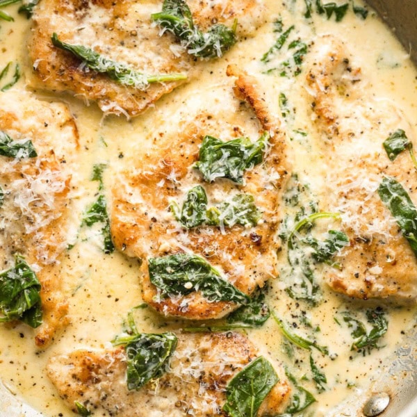 Close up of a skillet full of homemade creamy chicken Florentine.