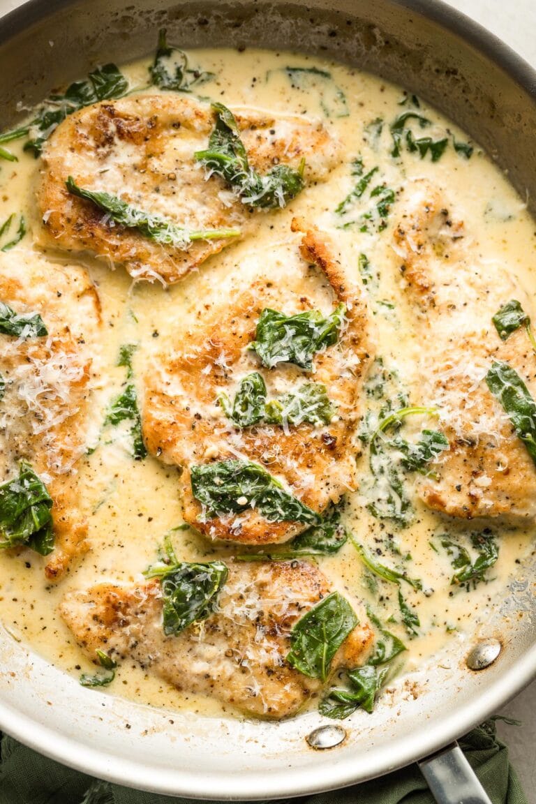 Close up of a skillet full of homemade creamy chicken Florentine.