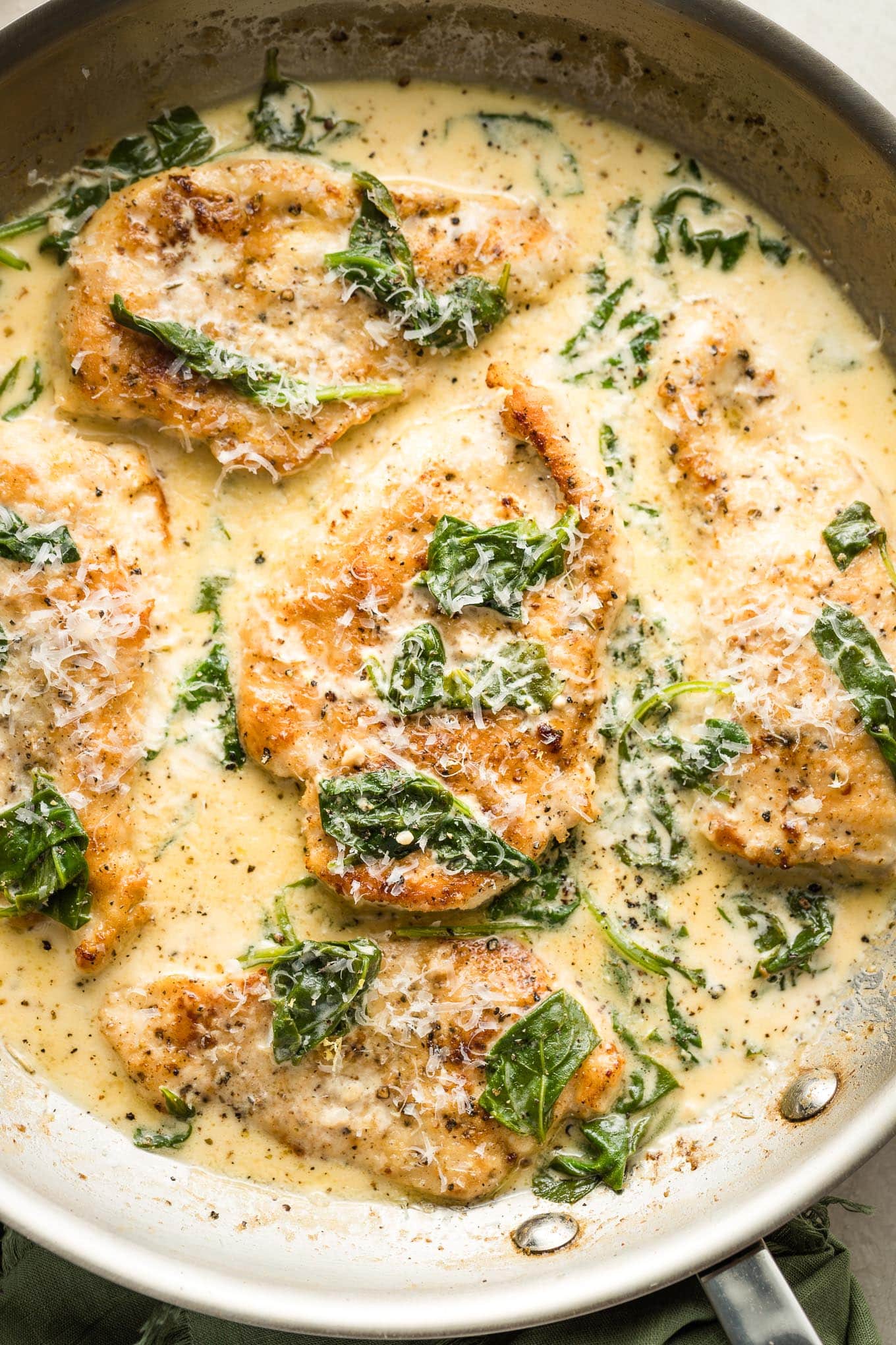 Close up of a skillet full of homemade creamy chicken Florentine.