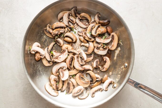 Mushrooms in a large skillet.