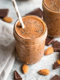 Close-up of a chocolate almond milk smoothie with chia seeds sprinkled on top.