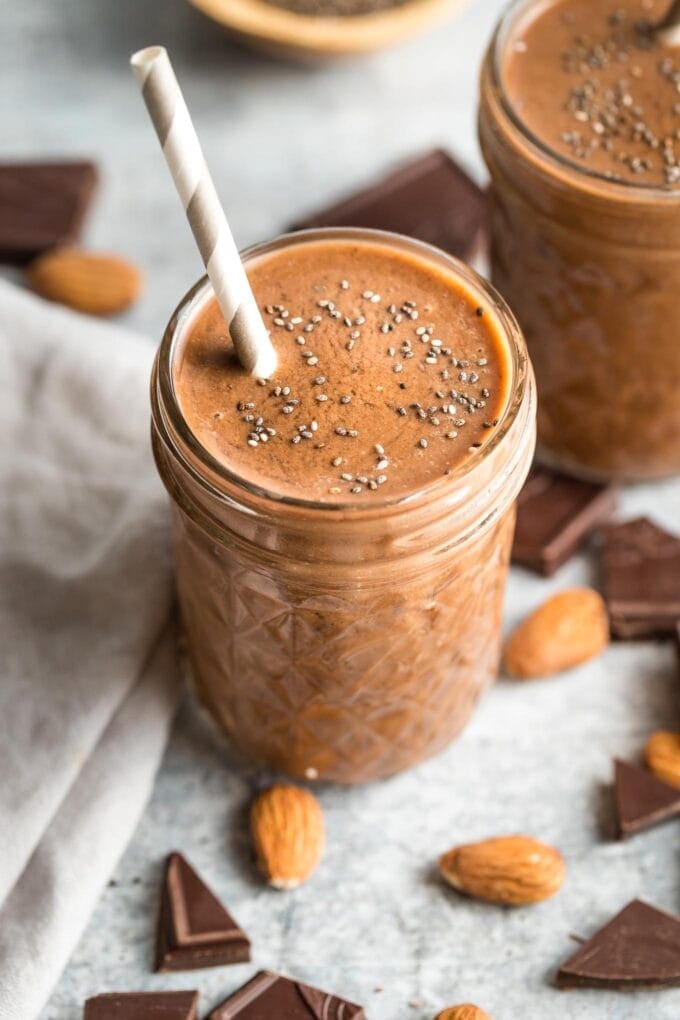 Close-up of a chocolate almond milk smoothie with chia seeds sprinkled on top.