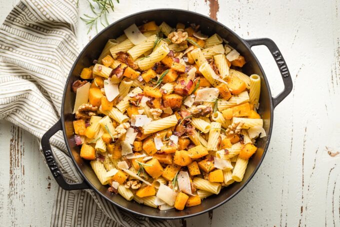 Skillet with pasta, squash, and extras added and tossed together.
