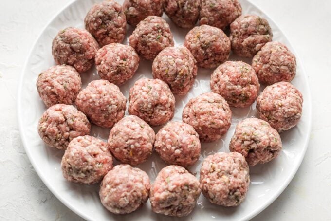 Shaped, uncooked lamb meatballs.