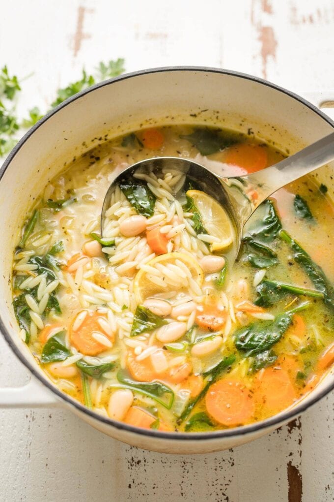 Ladle scooping up a serving of soup.