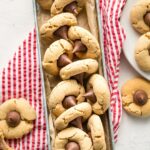 Galvanized metal tray full of peanut butter blossom cookies.