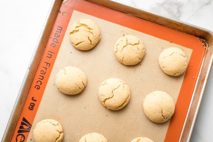 Baked peanut butter cookies, showing slight cracks on the tops.
