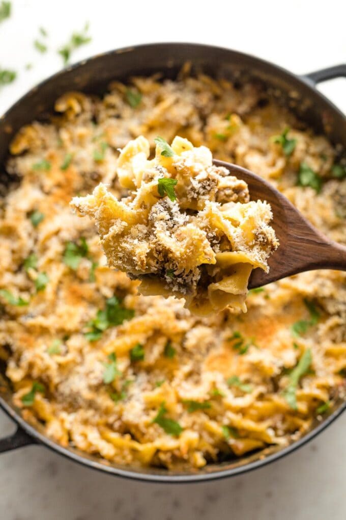 Close-up of a serving scoop of casserole.