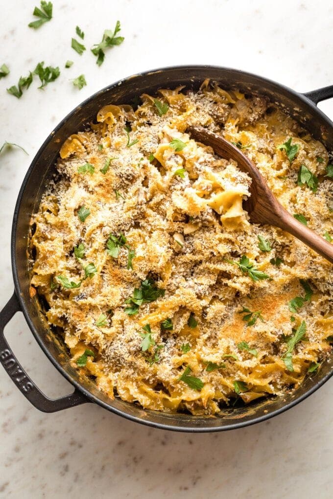 Large skillet full of sausage noodle casserole ready to serve.