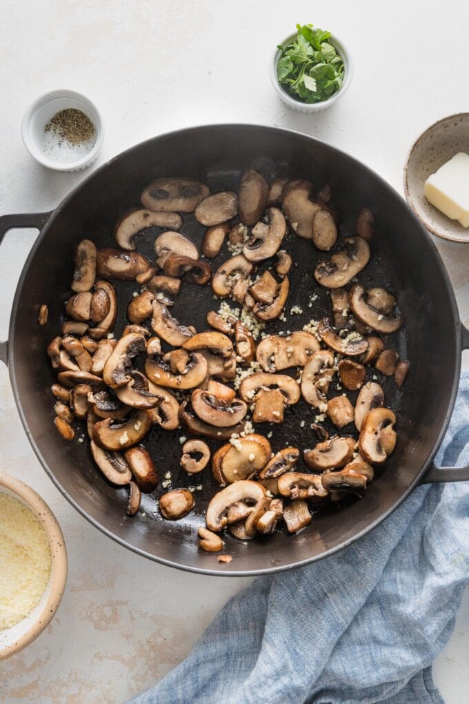 Deeply browned mushrooms sauteed in a cast iron skillet with butter and a smidge of minced garlic.