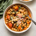 Bowl of Tuscan chickpea stew served with fresh Parmesan.