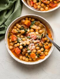 Bowl of Tuscan chickpea stew served with fresh Parmesan.