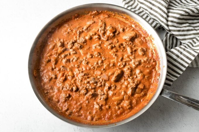 Beef, tomato sauce, and cream simmered in skillet.