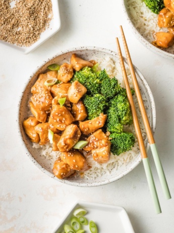 Bowl of homemade teriyaki chicken served with steamed broccoli and rice.