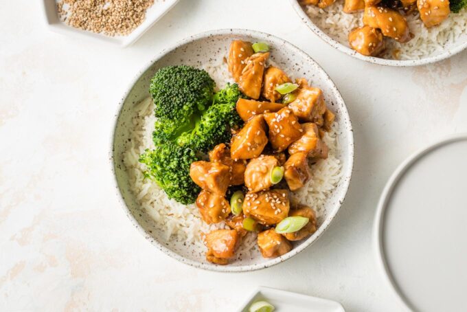 Bowl of homemade teriyaki chicken served with steamed broccoli and rice.