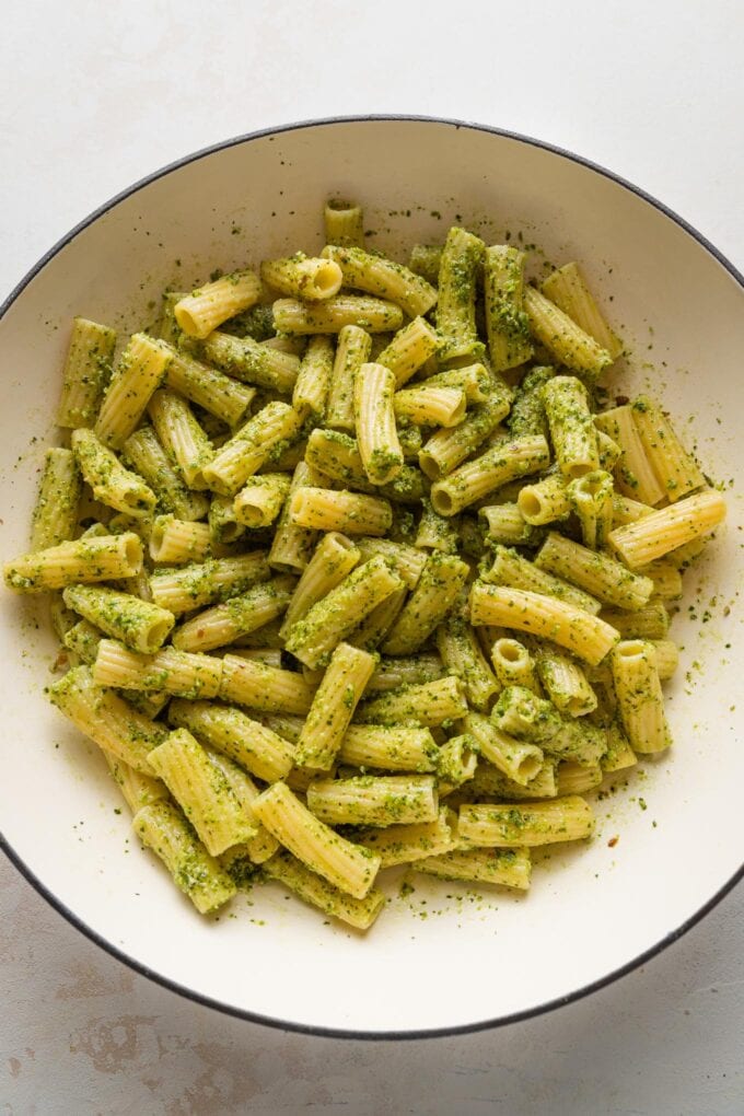 Pesto rigatoni in a large skillet.