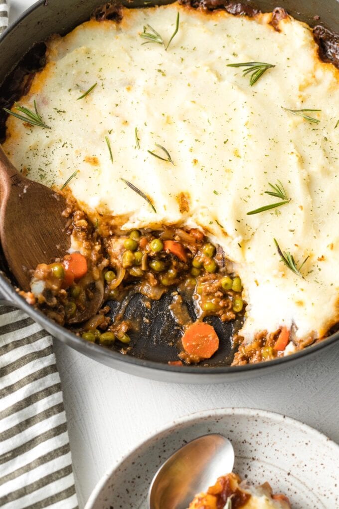 Close up of vegetarian shepherd's pie with a serving scooped out of the pan.